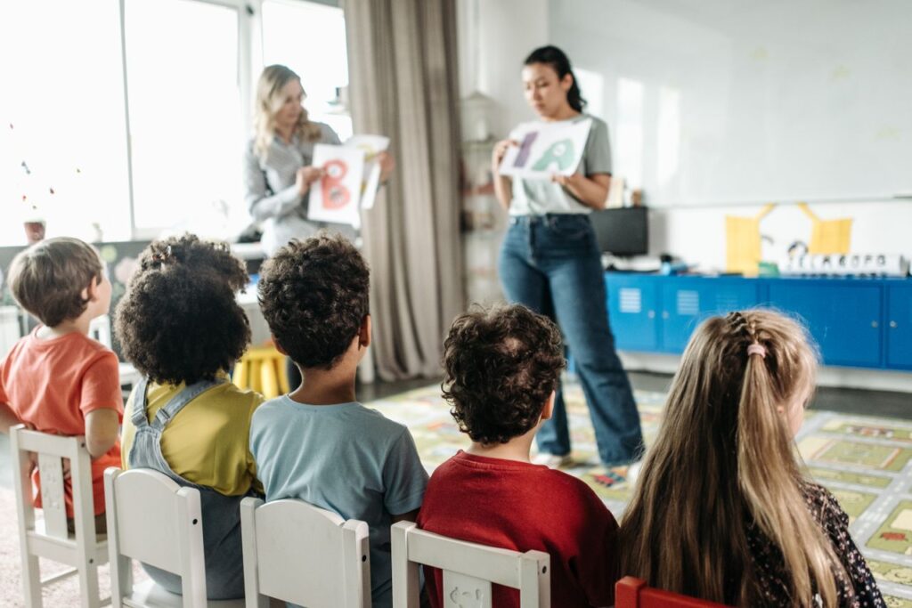 Mastering the First Impression: Your intriguing post title goes here Children in a kindergarten classroom engaging with letters during a learning session.